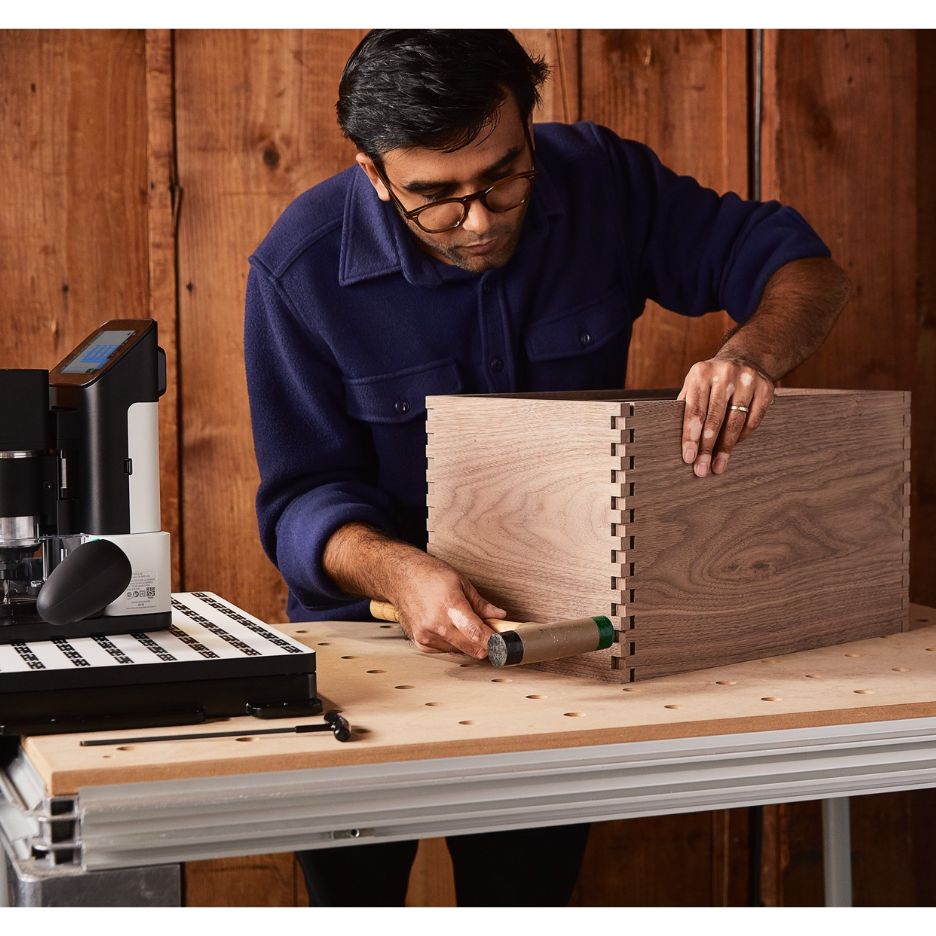 Man assembling box made using Origin and Workstation