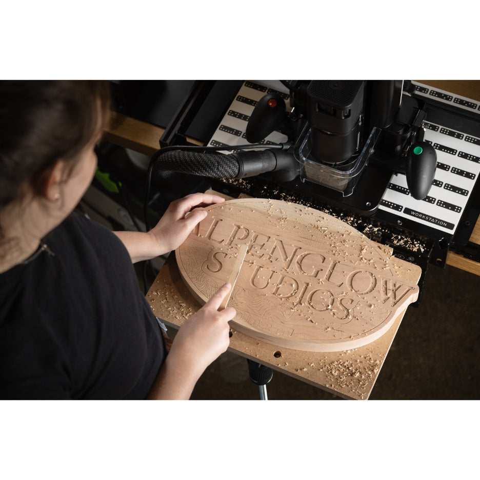 Woman working on a routed sign on top of Shaper Tools Shelf Upgrade Kit