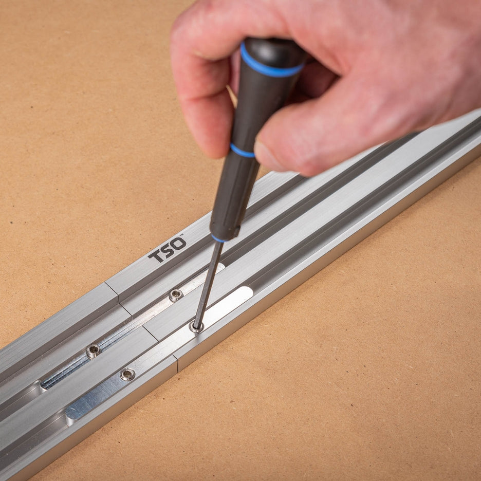 Closer look at screws being tightened using a screwdriver on TSO Products Extended Miter Fence
