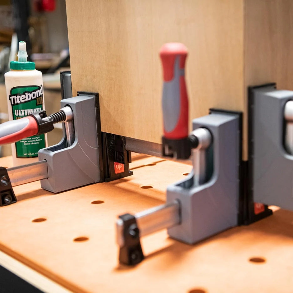 UJK Tools Clamp Stand with clamps attached on a MFT table with a wooden piece being glued up