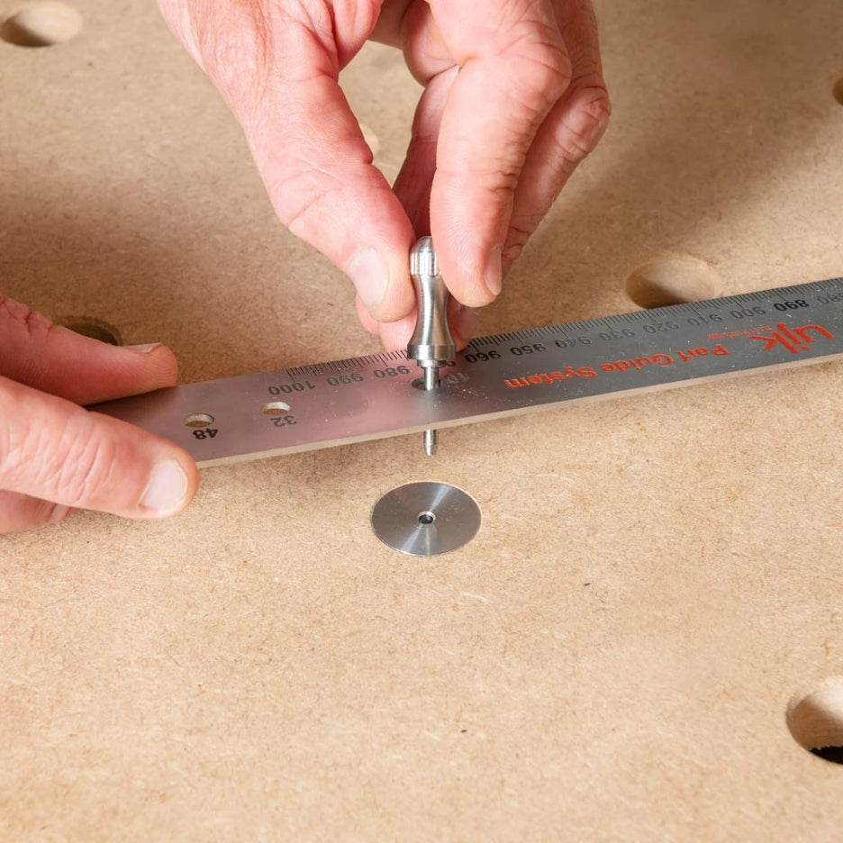 UJK Parf dog inserted in MFT table and hands holding a ruler and a metal pin