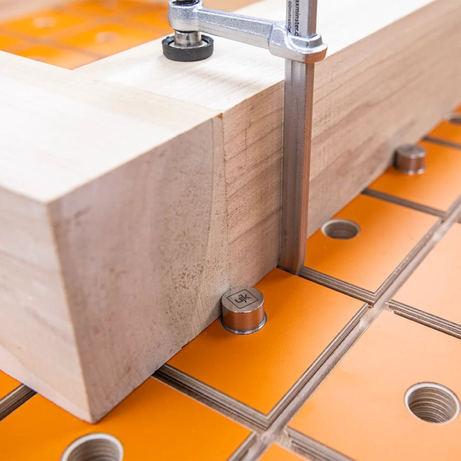 Close-up of a wooden block with metal clamps on UJK Tools Rail Clamp MFT Top
