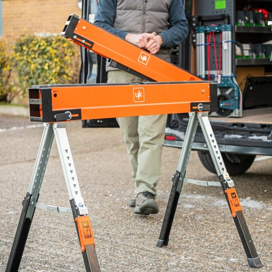 UJK Tools Sawhorses with a person in the background near a vehicle.