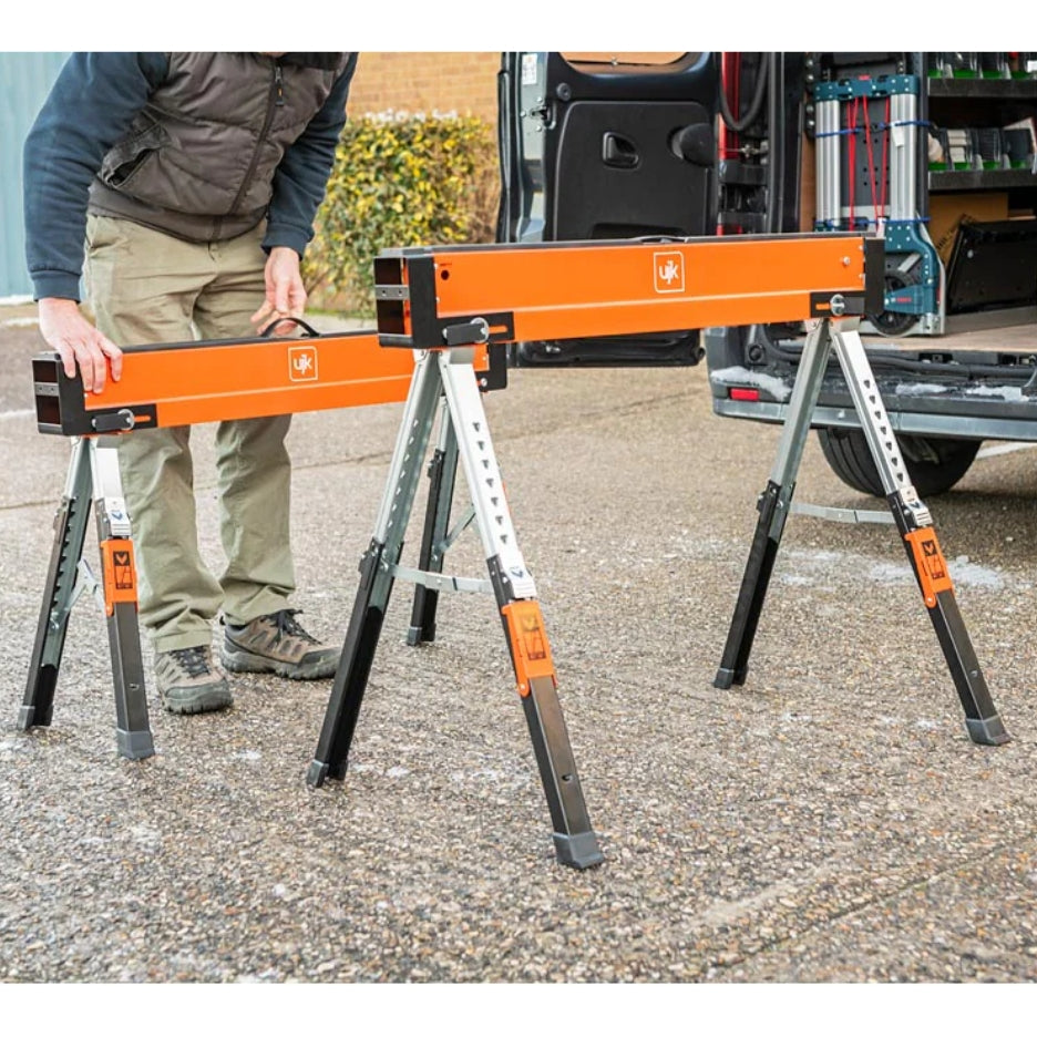 Person using UJK Tools Sawhorses outdoors with a vehicle in the background