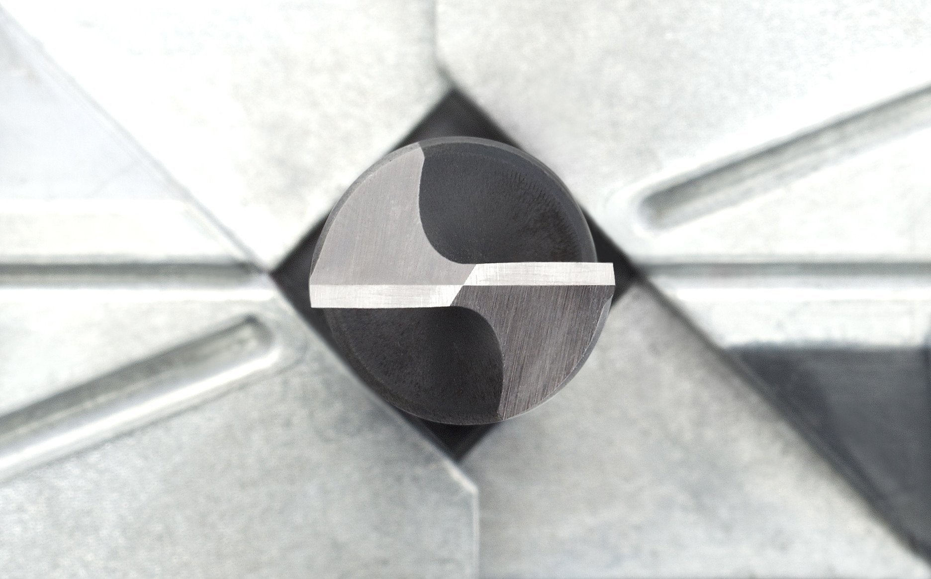 A perfect grind on the cutting edges of a twist drill bit held in the Tormek DBS-22 Drill Bit Sharpening Jig.
