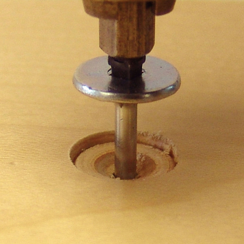 A PowerHead screw with square recess is driven into a recess drilled with FlushMount Drill System.