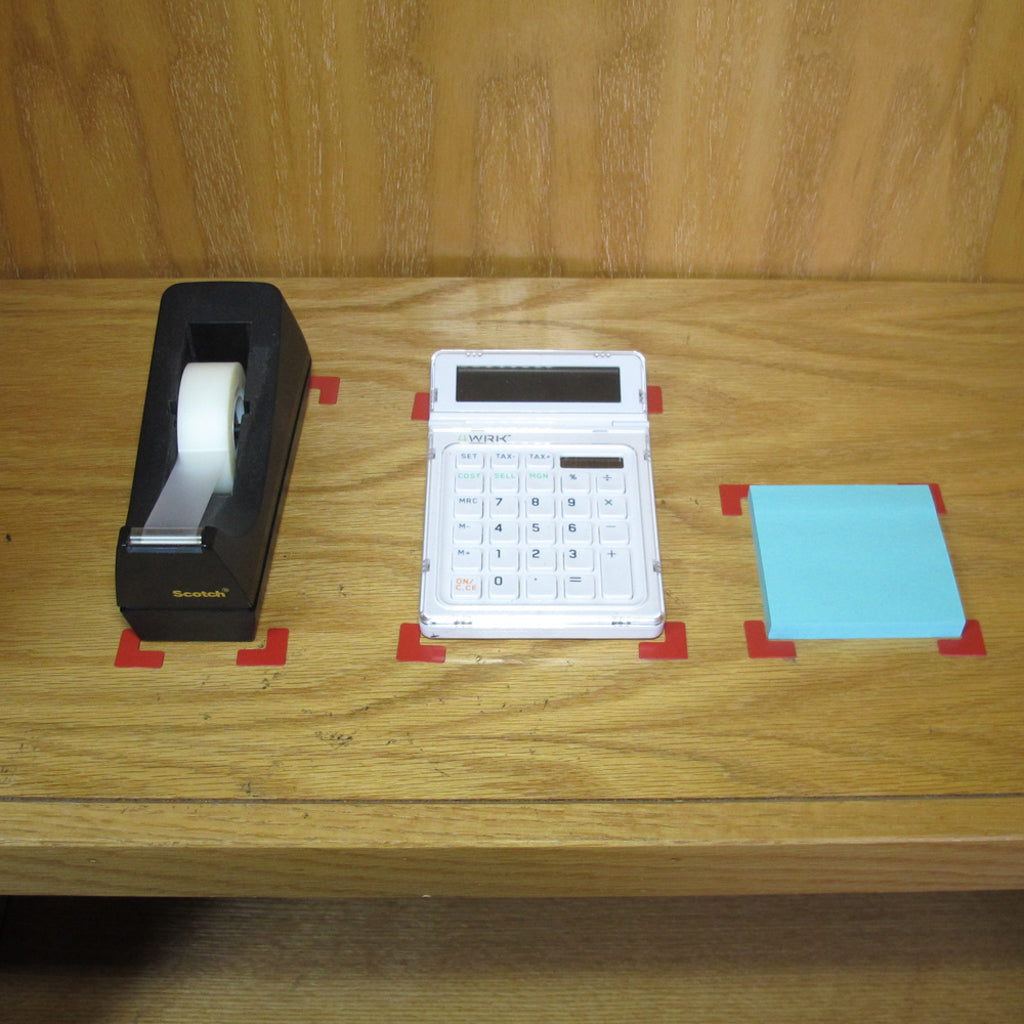 Small Kaizen Korners clearly mark the homes of commonly used items on a shelf.