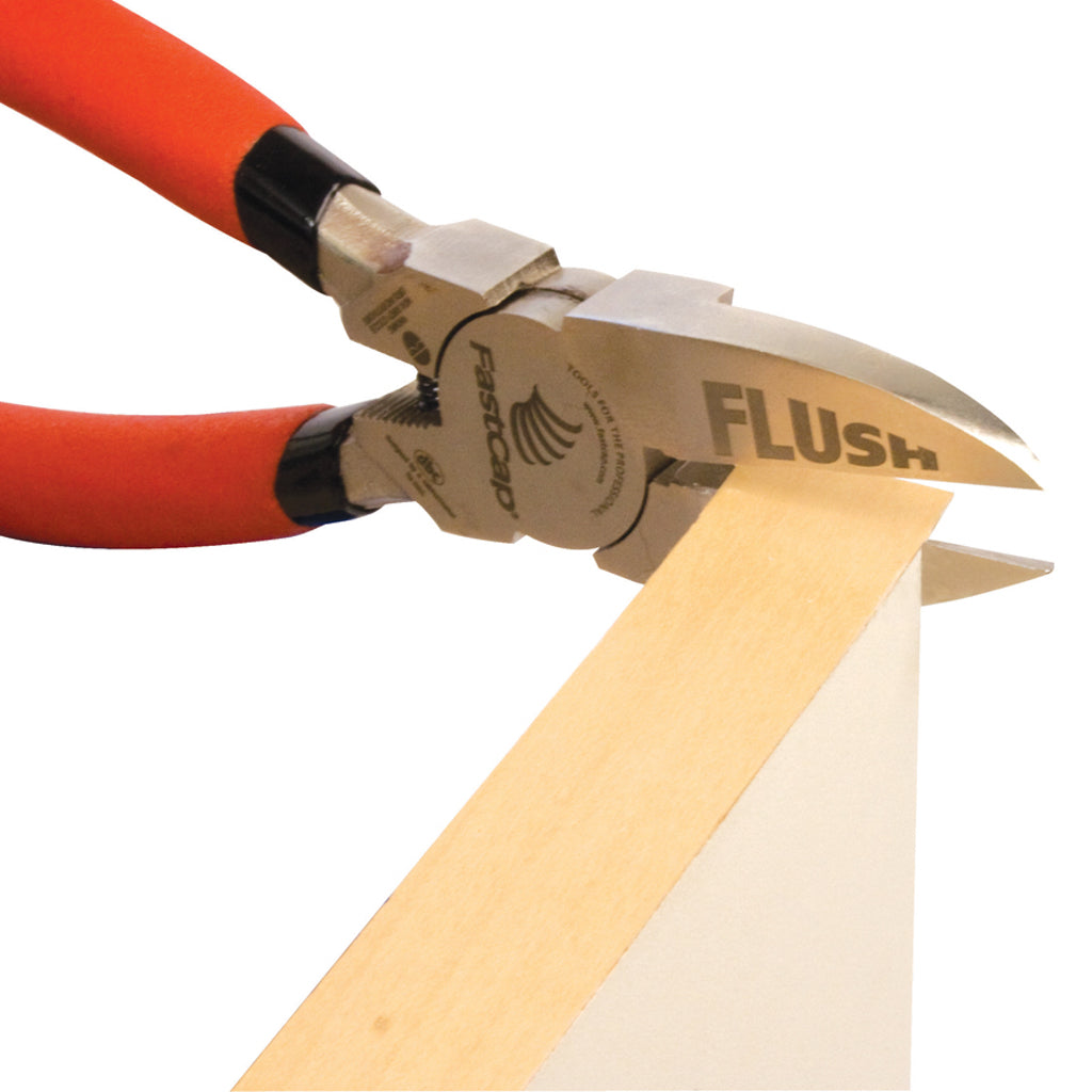Fastcap Macro Flush Cut Trimmers in position to trim the end of an overhanging length of wood edge banding.