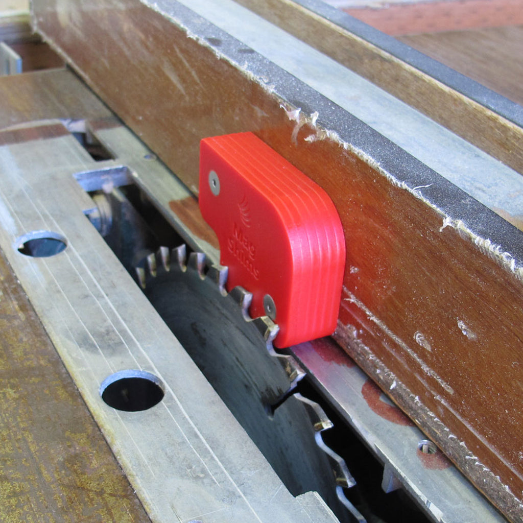 6 Mag Shims are being used to set a table saw fence 3/4" away from the saw blade.