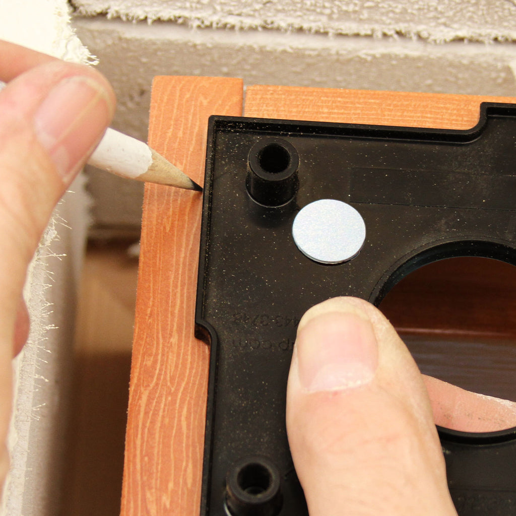A worker uses the FastCap Reveal Square to quickly and accurately mark two adjacent offsets.