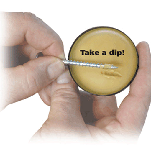 A person rolls a wood screw in a tin of ScrewWax.