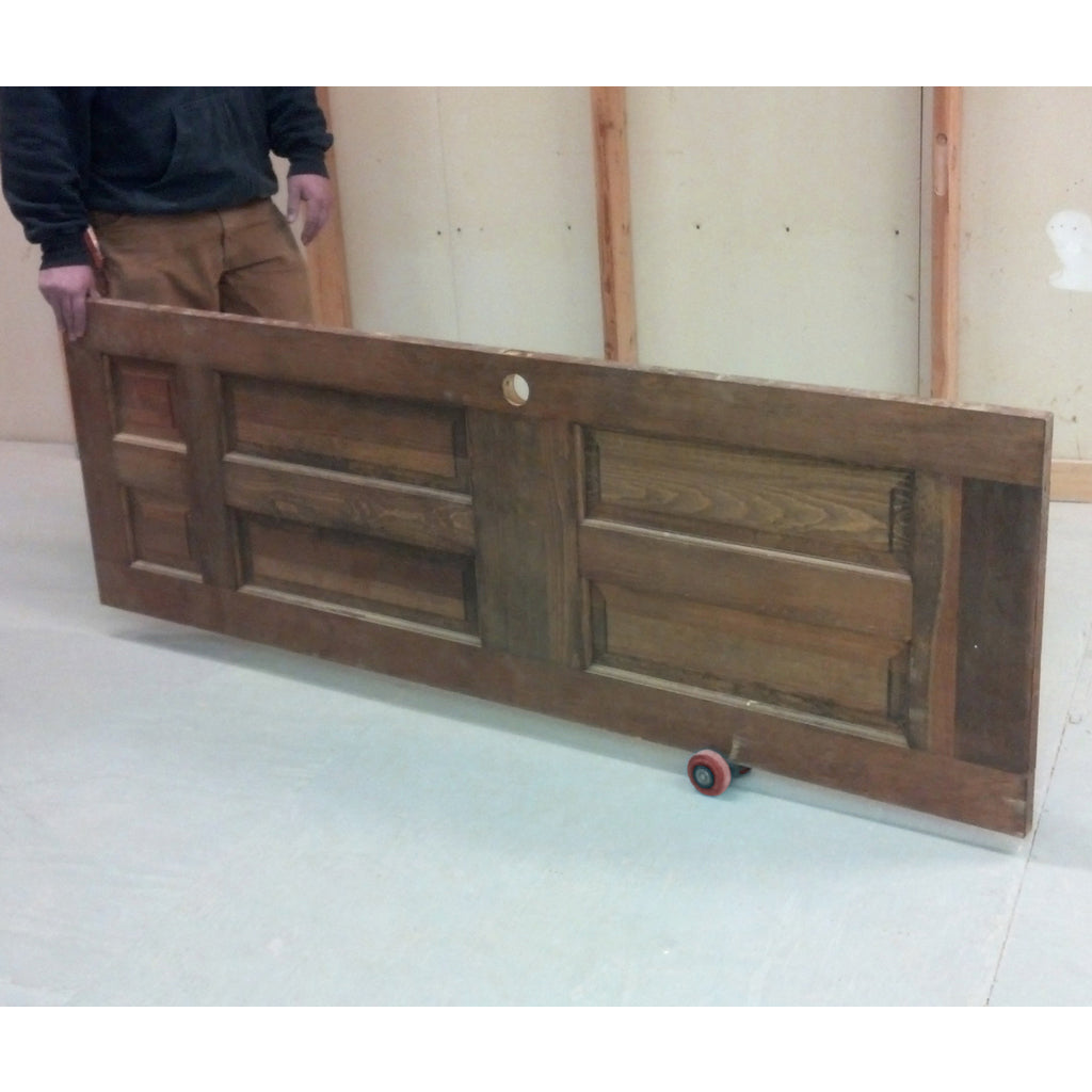 A worker moves a tall door by himself, with one end supported by the Speed Skate.