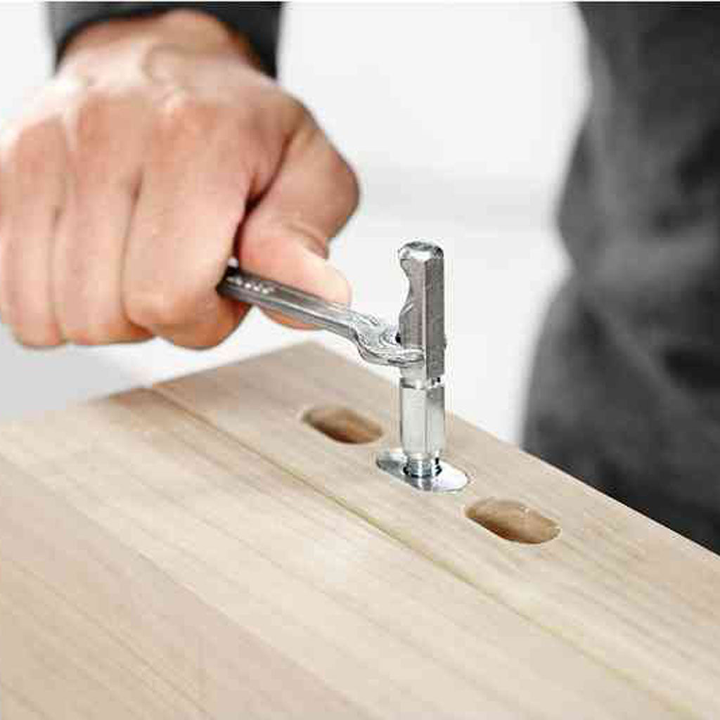 Drive the anchor bolt into the split anchor with a wrench or hex key through the hole to expand and lock it into place.