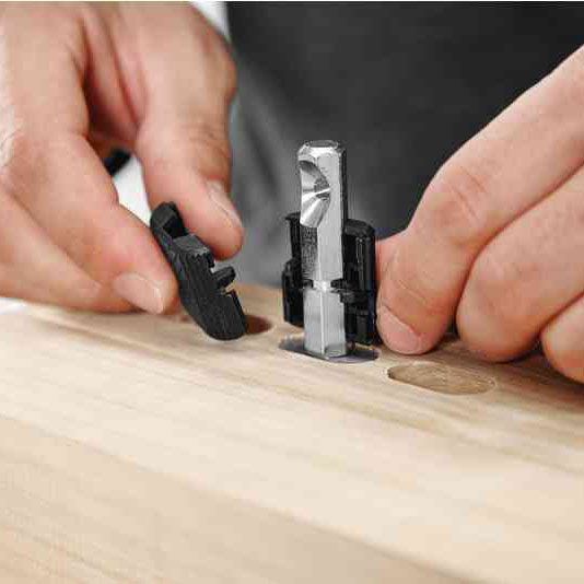 Half shells snap around the anchor bolt to provide alignment and distribute lateral forces to a broader area of the material.