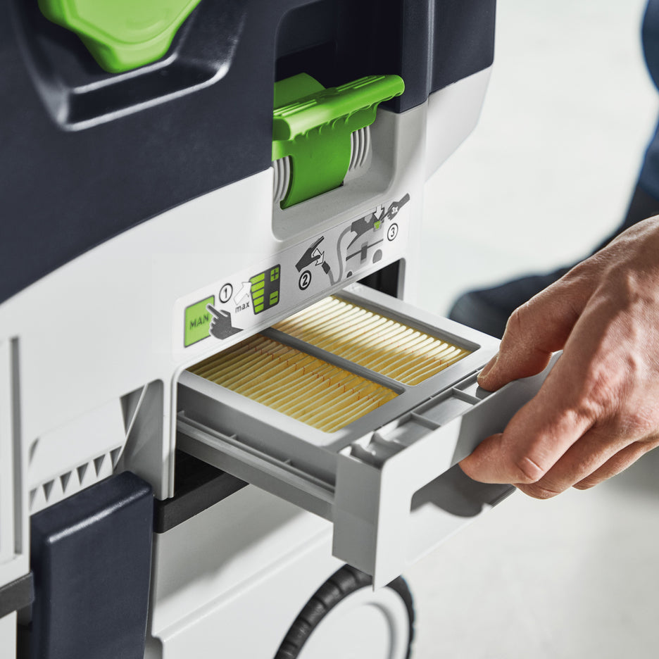 Man pulls out external filter drawer to check cleanliness of HEPA filter in the Festool CTC MIDI I Dust Extractor.