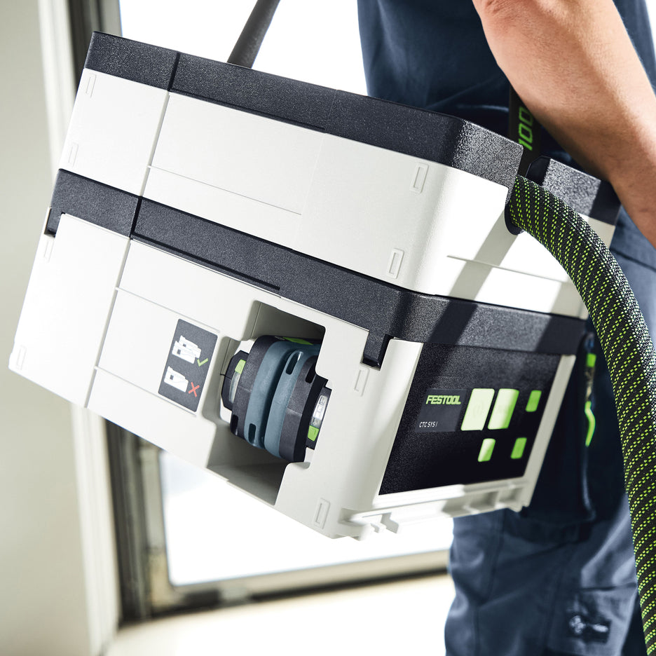 Man carries CTC SYS Cordless Dust Extractor with strap over his shoulder.