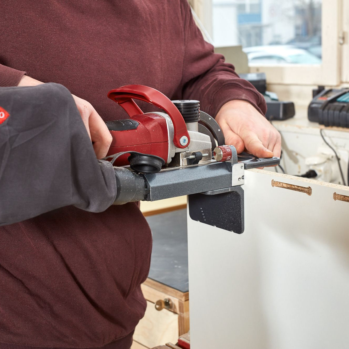 Lamello Zeta P2 Cordless Biscuit Joiner cutting P-slot in face of melamine particle board panel