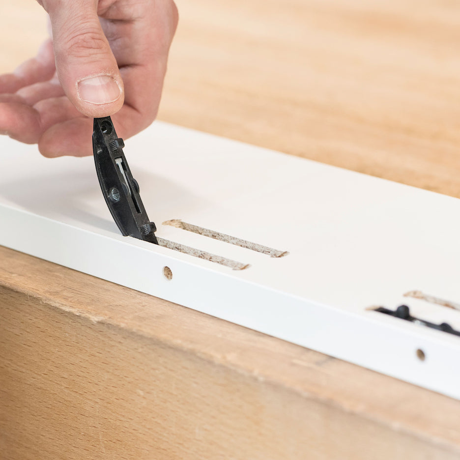 Inserting P-system connector with hand into P-system slot cut with Lamello Zeta P2 Cordless Biscuit Joiner.