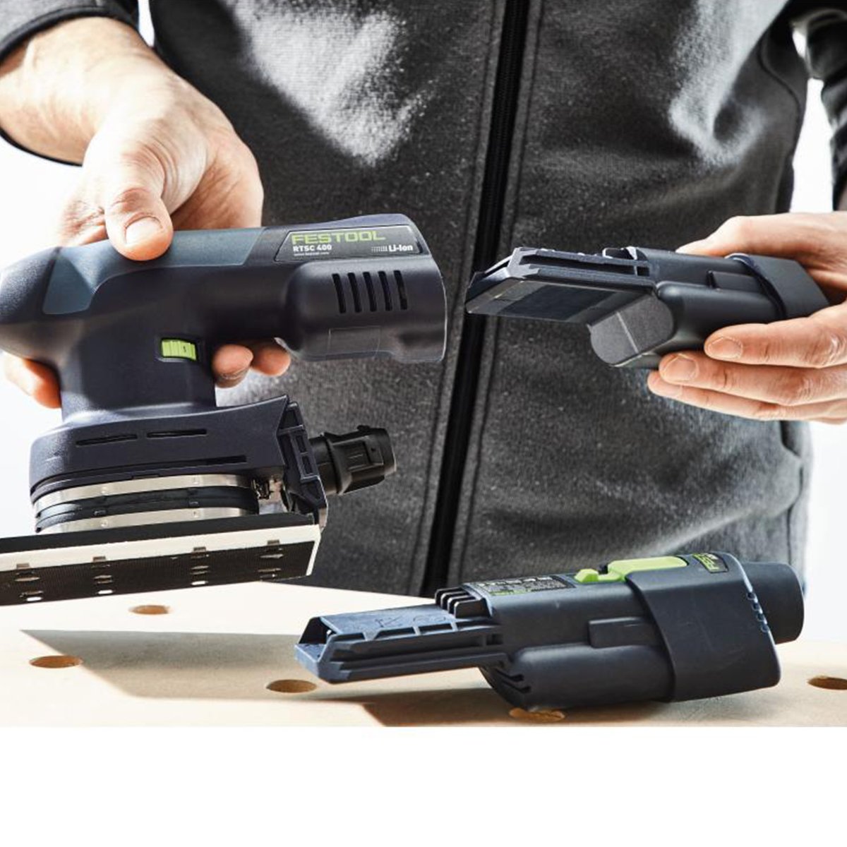 An operator has removed one battery and is installing a freshly charged Ergo battery into the back of the RTSC 400.