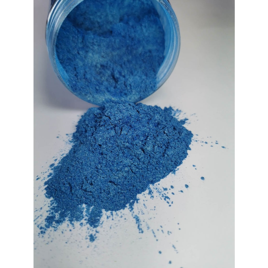 A jar of Royal Blue Ryver Epoxy Aurora Metallic Pigment on its side showing the actual colour and consistency of mica.