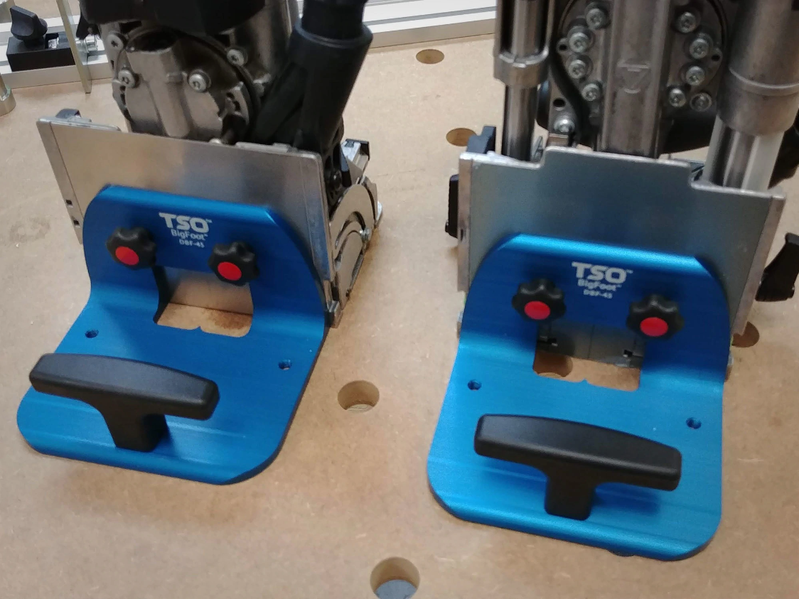A pair of TSO Products BigFoot right angle supports mounted on a Festool Domino DF 500 and XL DF 700, on an MFT work table.