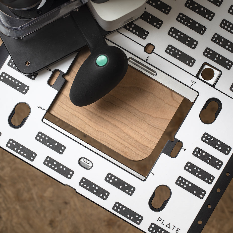 Shaper Origin and Plate used to round over the corner of a workpiece.