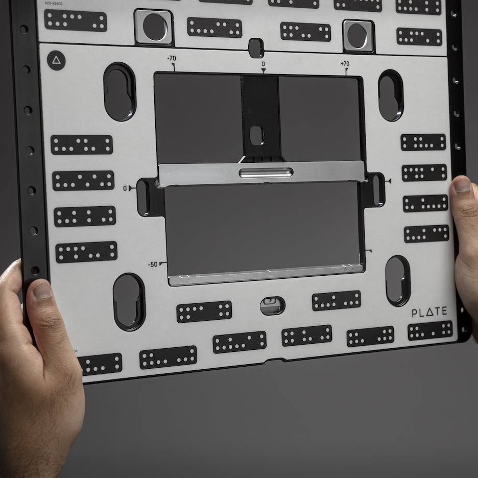 Man holds Shaper Plate in his hands.