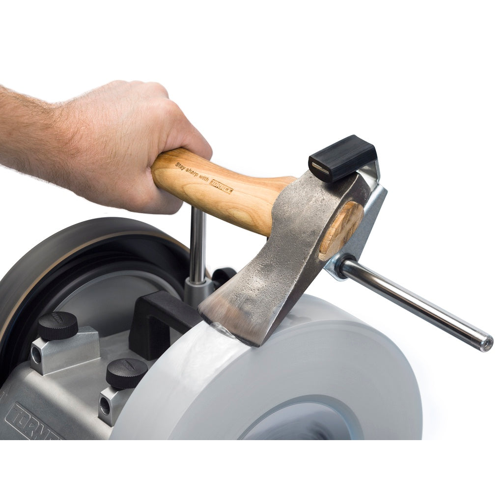 A hatchet is gripped in the SVX-170 Carpenter Axe and Hatchet Jig and a user grinds an even bevel on the edge.