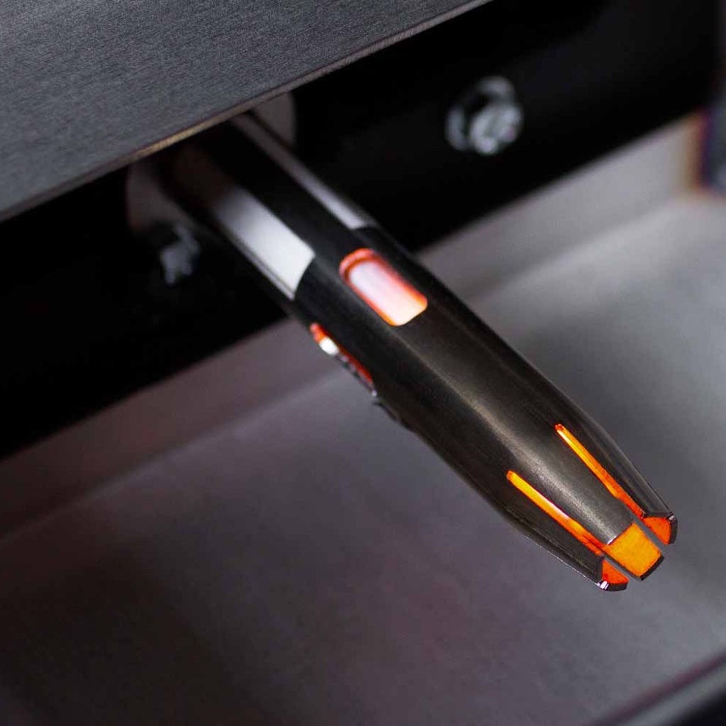 The ceramic igniter is shielded by a metal shroud for protection.