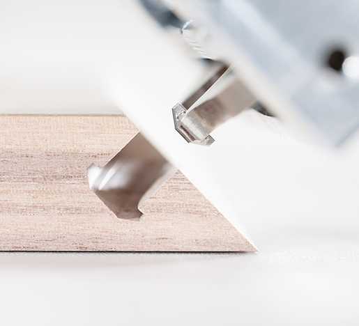 The Lamello Zeta P2 biscuit joiner cuts a T-shaped slot that captures the biscuit to resist pull-out.