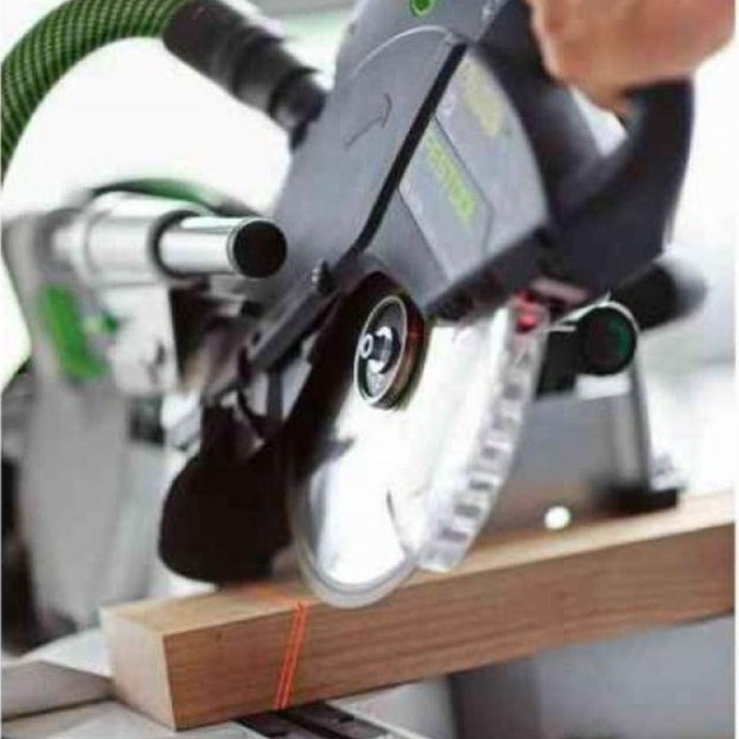 A woodworker is making a bevel cut with the Kapex. Two laser lines are visible across the 2 inch thick hardwood.