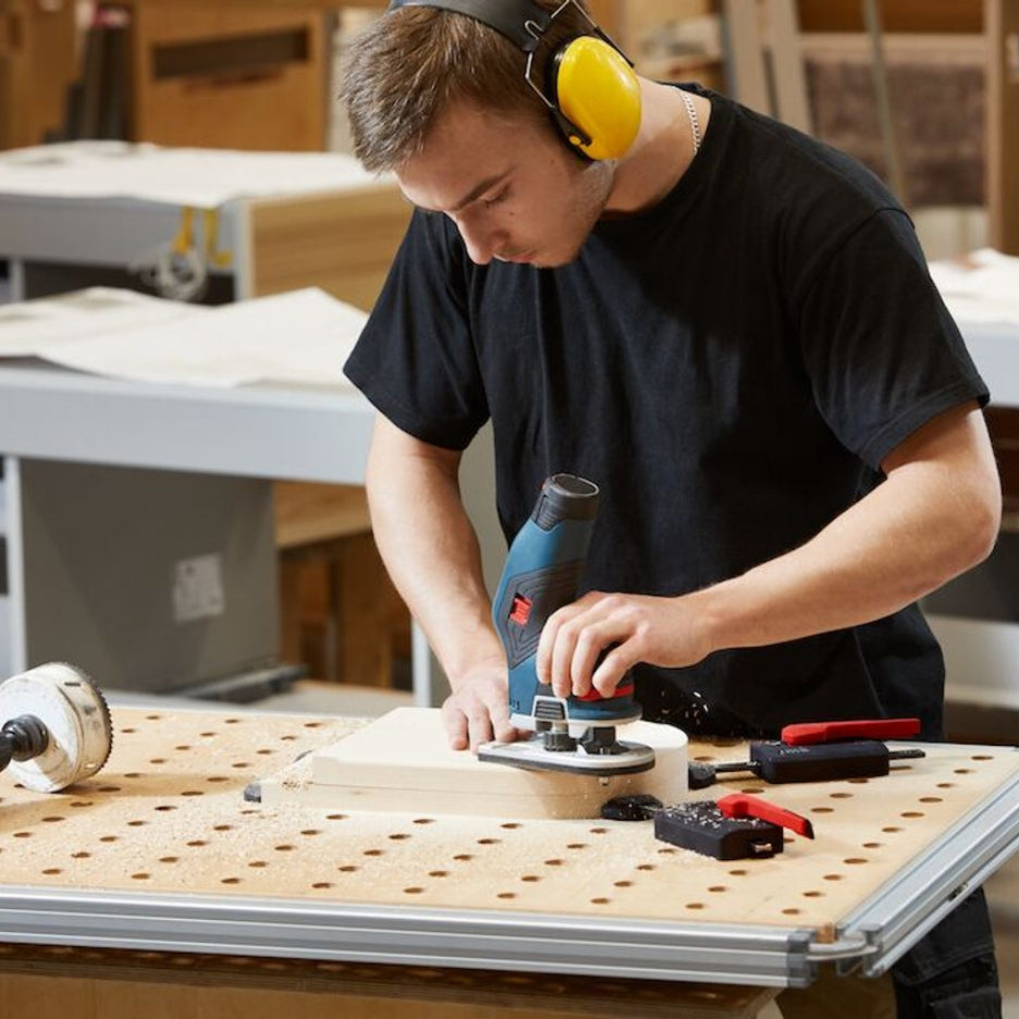 Man finishing work while Bessey Tools Horizontal Table Clamp Fixture holds it in place