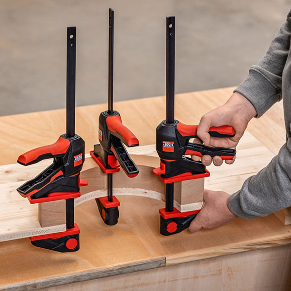 Man holding Bessey Tools Large Trigger Clamps with 360° rotating handle