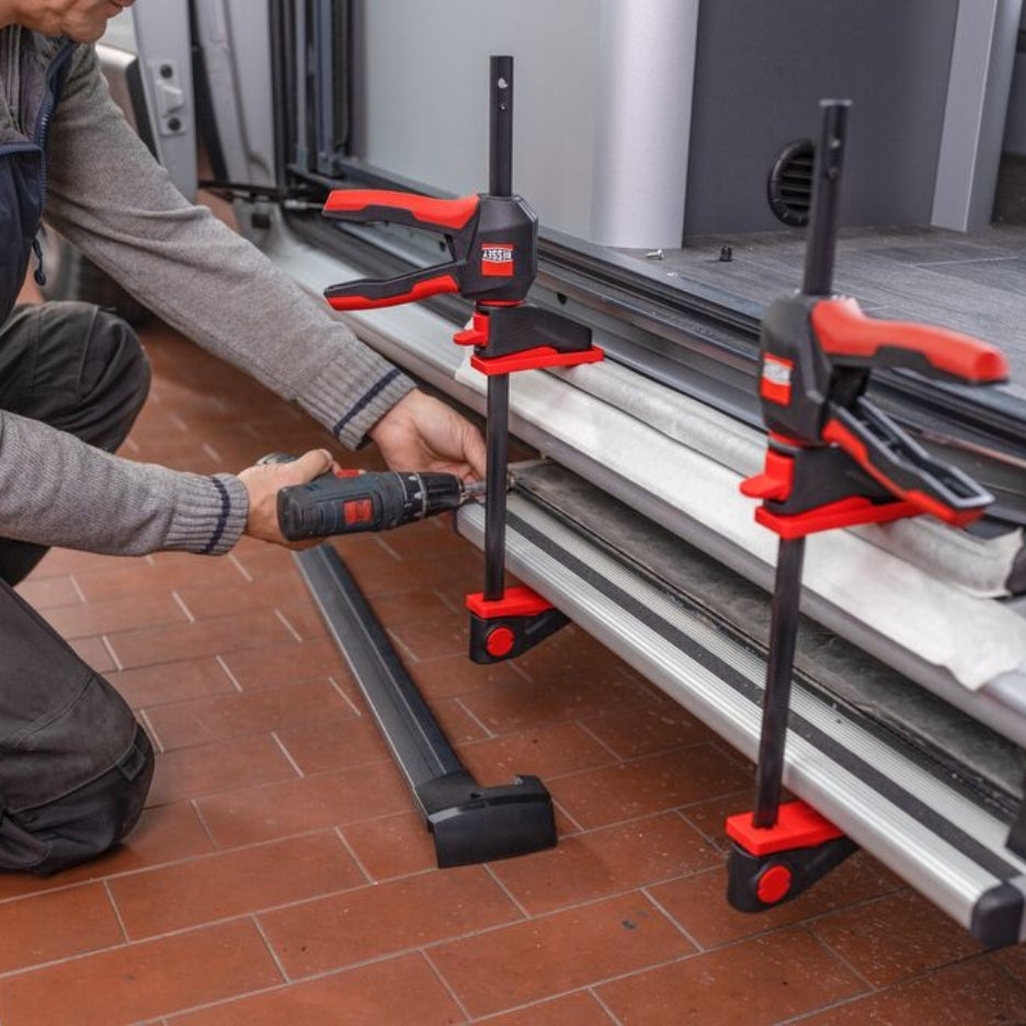 Bessey Tools Trigger Clamps holding materials in place while screw is inserted 