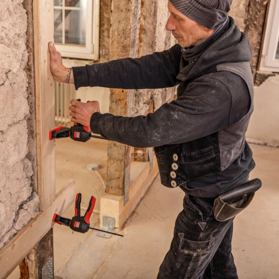 Man working on a construction project using Bessey Tools Trigger Clamps