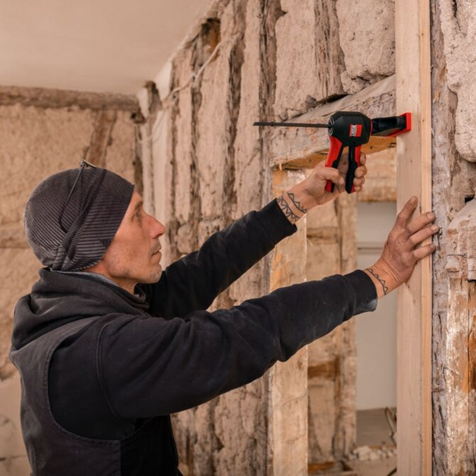 Man holding wood frame and clamping it with Bessey Tools Trigger Clamps