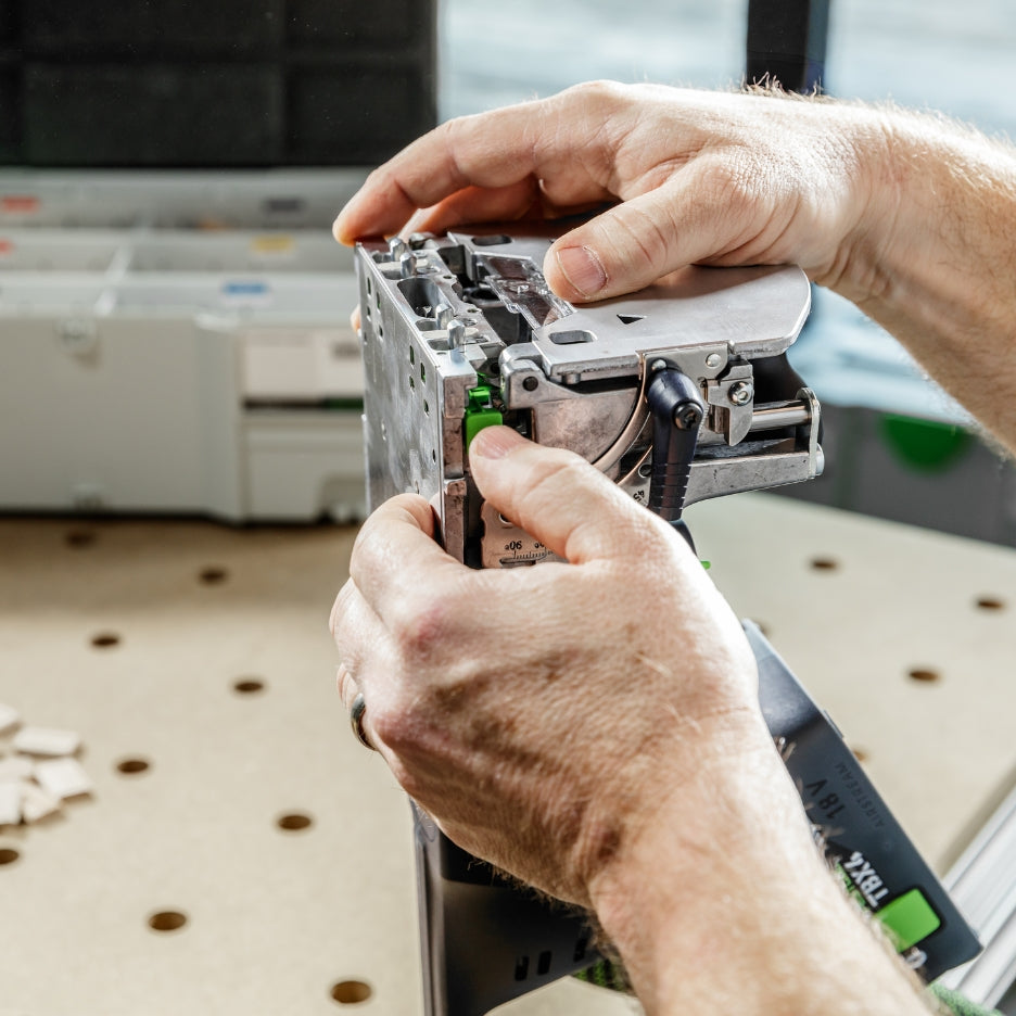 Hands adjusting Festool Cordless Domino Joiner DFC 500