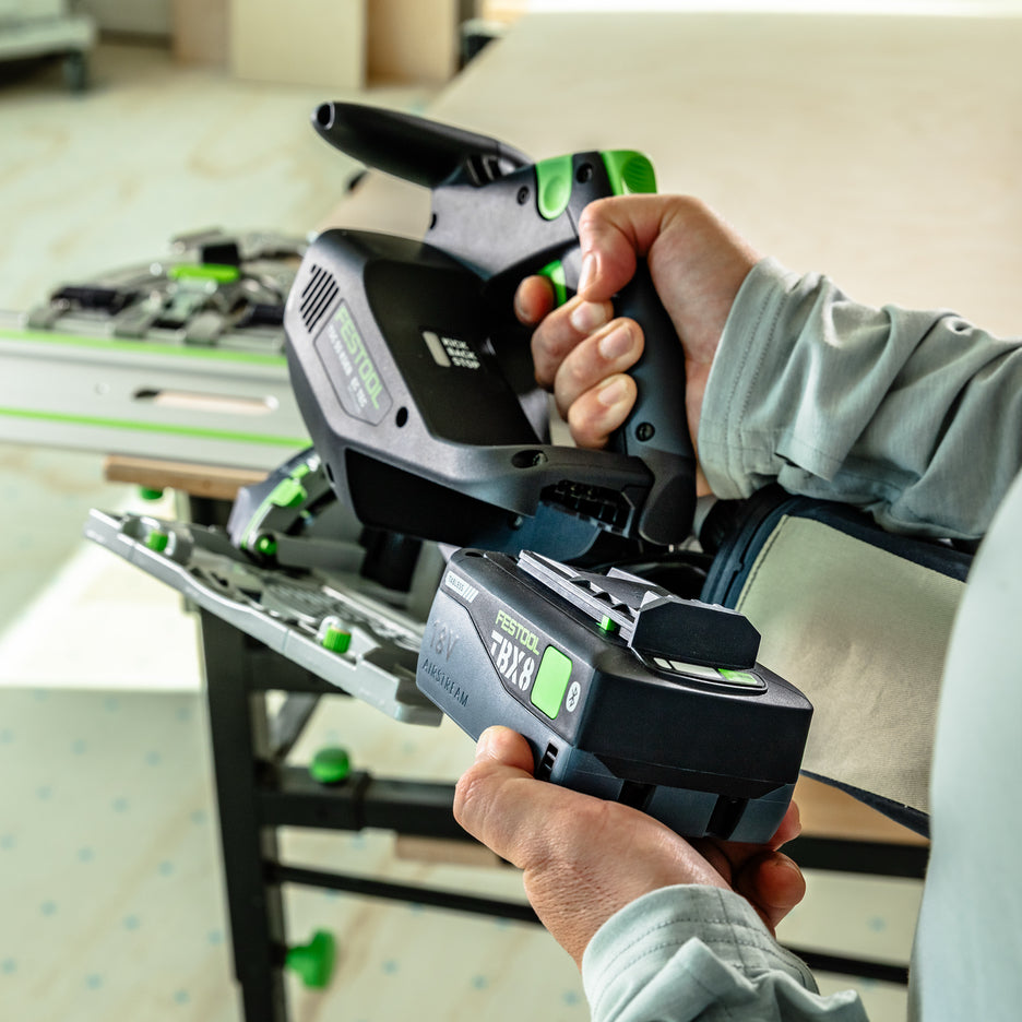 User slides Festool TBX8 tabless battery onto TSC 55 KS saw.