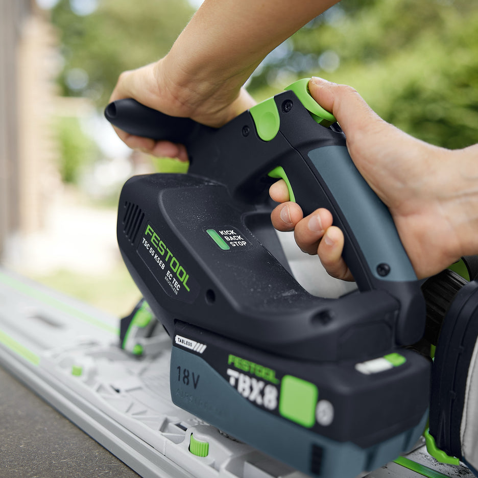 Rear view of Festool TSC 55 KS showing ergonomic grips, controls, streamlined motor housing, battery, and KickbackStop.