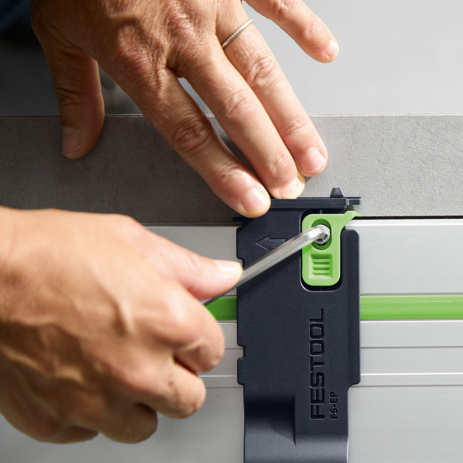 Carpenter turns the locking bolt for the kerf indicator using the 5mm hex key from the Festool track saw.