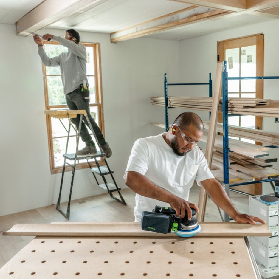 Man sanding a piece of wood using a Festool sander and Festool Grit Abrasives Granat PROfile D150 M GR PRO