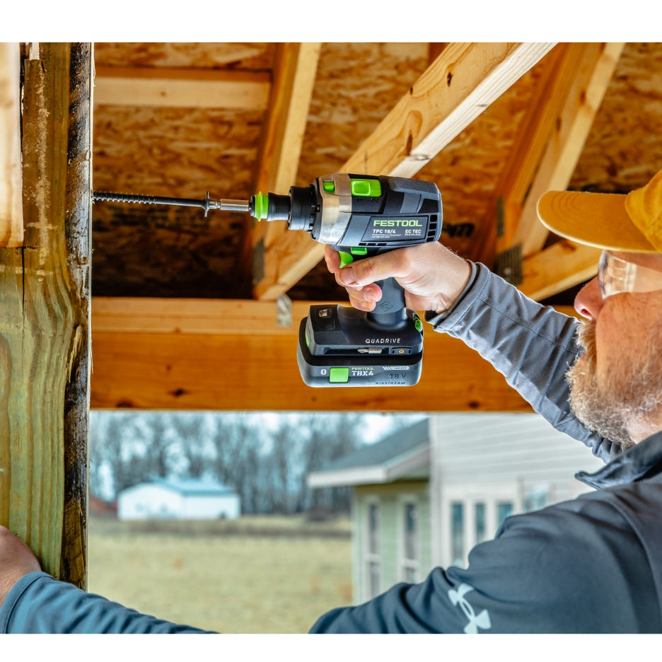 Man using Festool Percussion Drill on lumber
