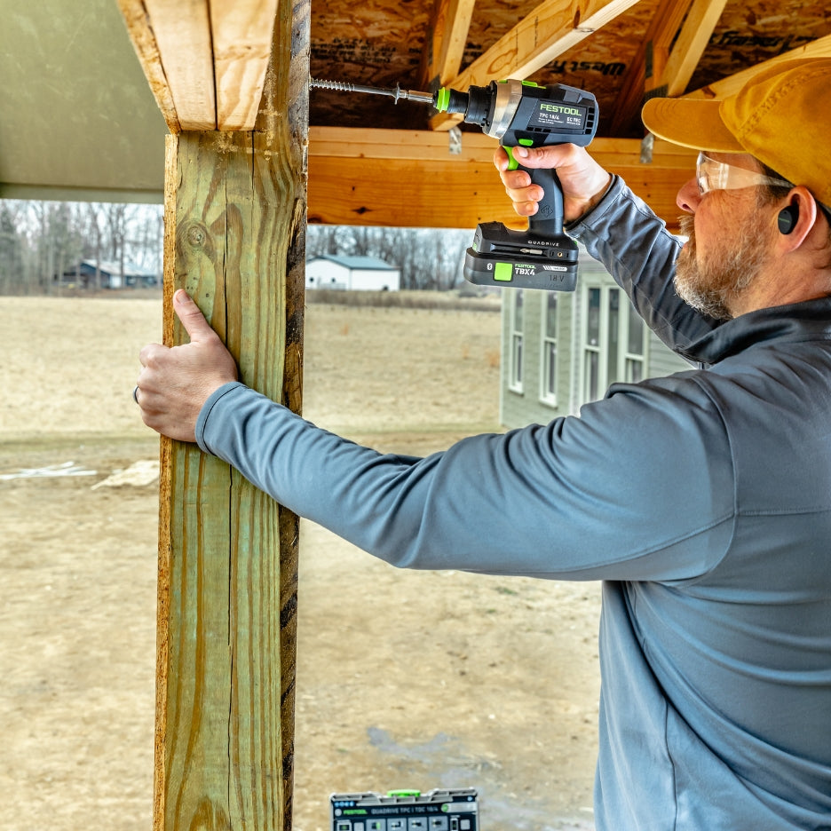 Man using Festool Percussion Drill on lumber