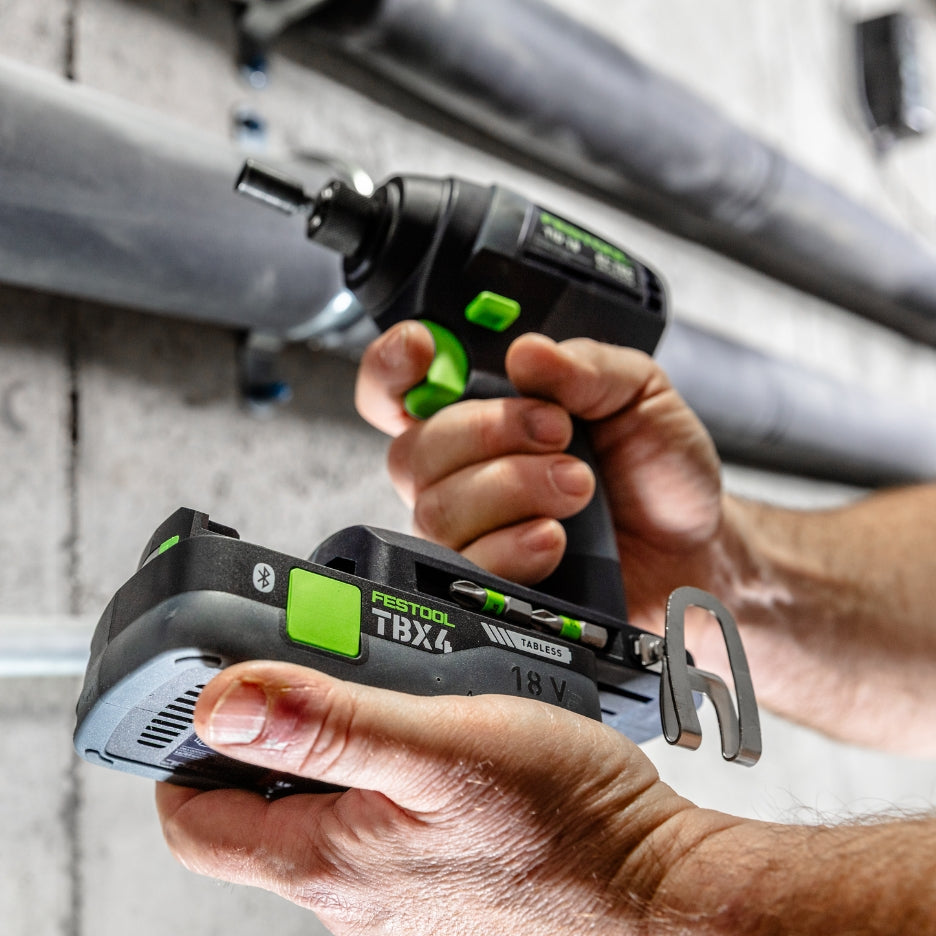 Hands holding Festool Impact Driver and inserting battery