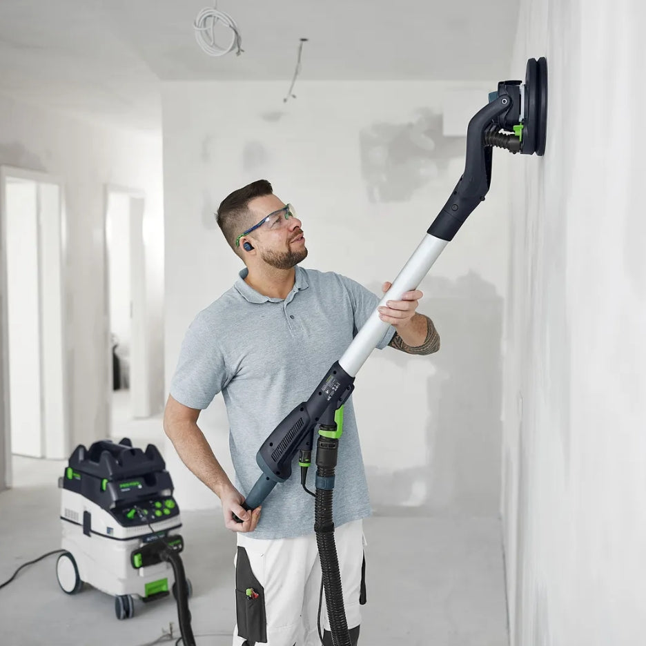 Man using Festool PLanex with Festool Interface Pad to sand wall