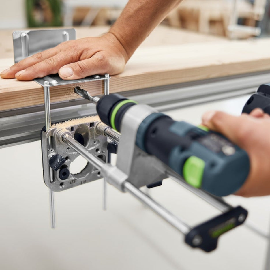 Person using Festool Mobile Drilling Attachment MB 40 on the side of a piece of wood 