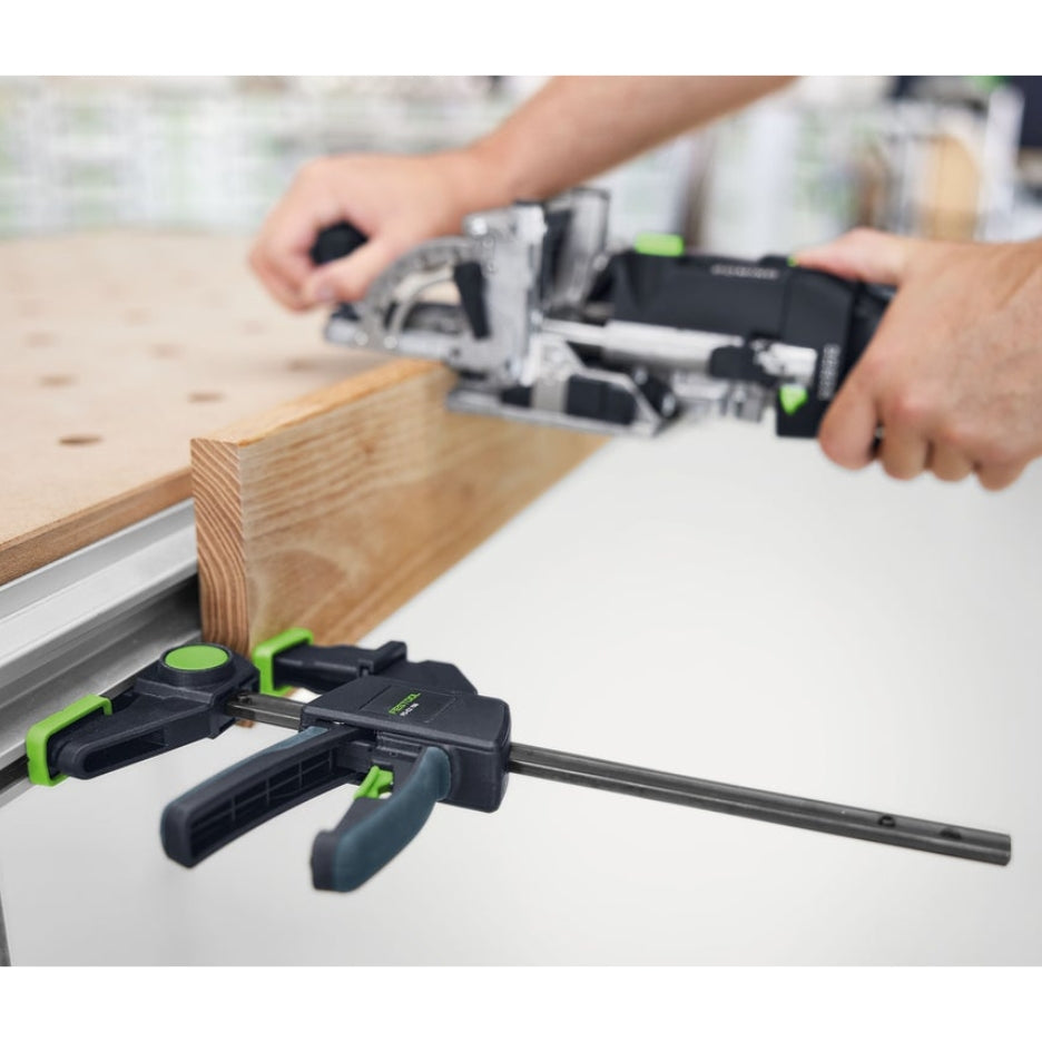 Person using a jigsaw to cut wood with Festool One-Handed Clamp FS-EZ 150 holding the wood in place.