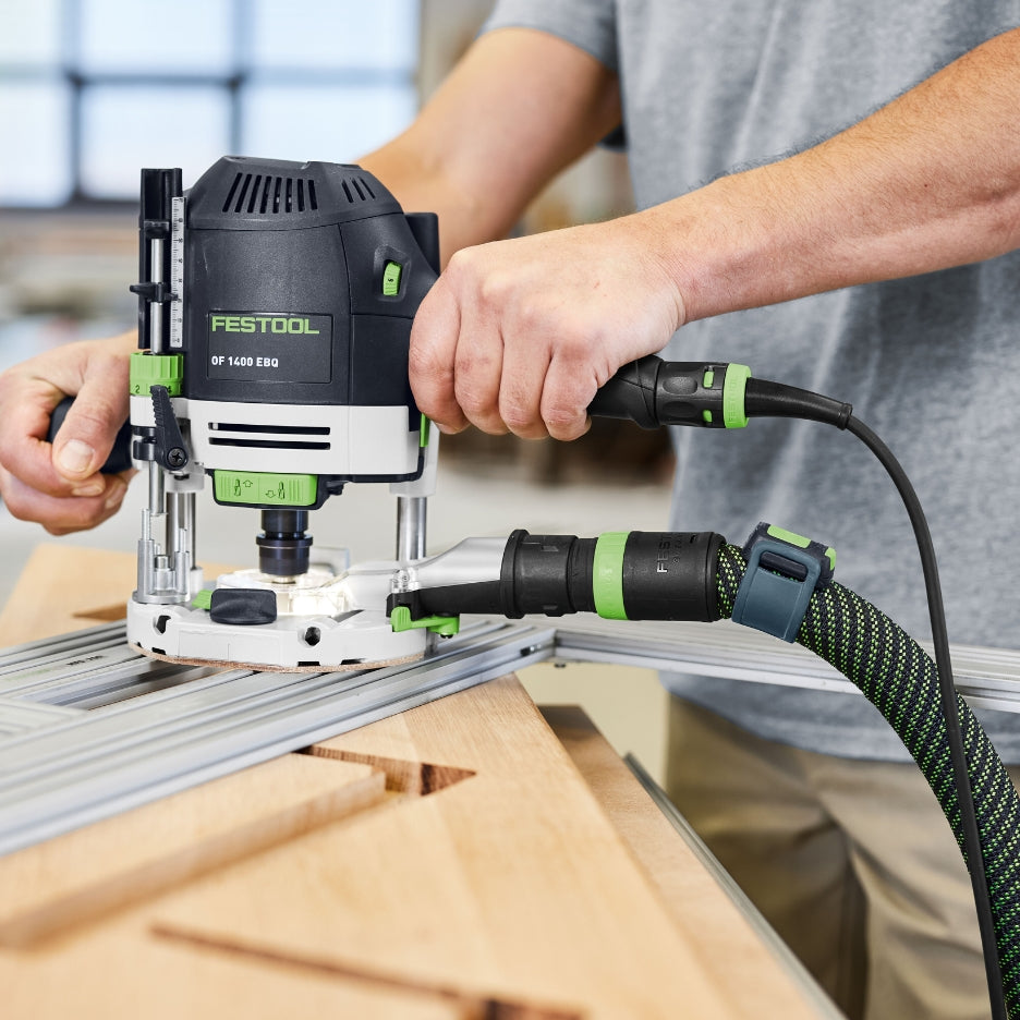 Person using Festool Plunge Router OF 1400 EQ-F-Plus on a piece of wood with a blurred background