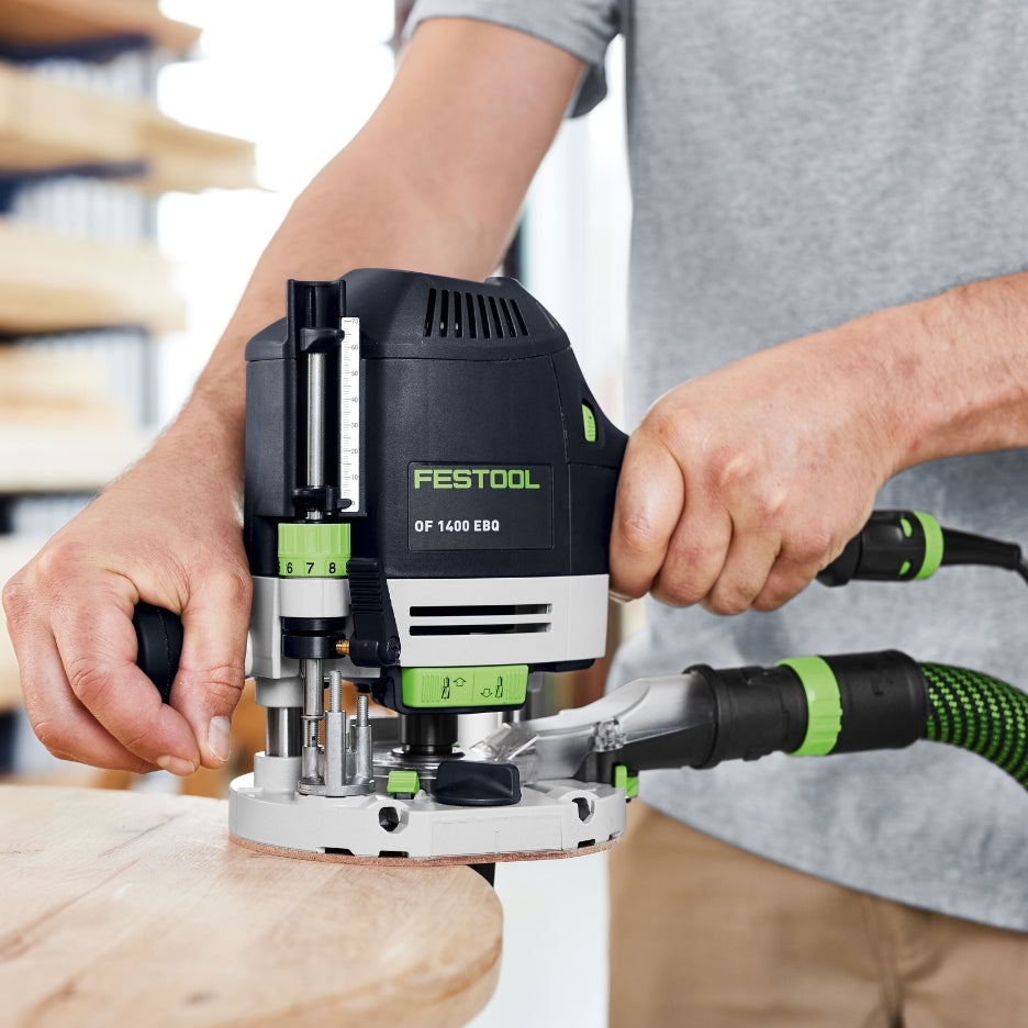 Person using Festool Plunge Router OF 1400 EQ-F-Plus on a wooden surface