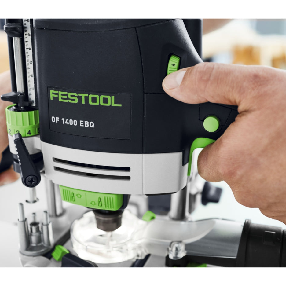 Festool Plunge Router OF 1400 EQ-F-Plus held by a person with a blurred background